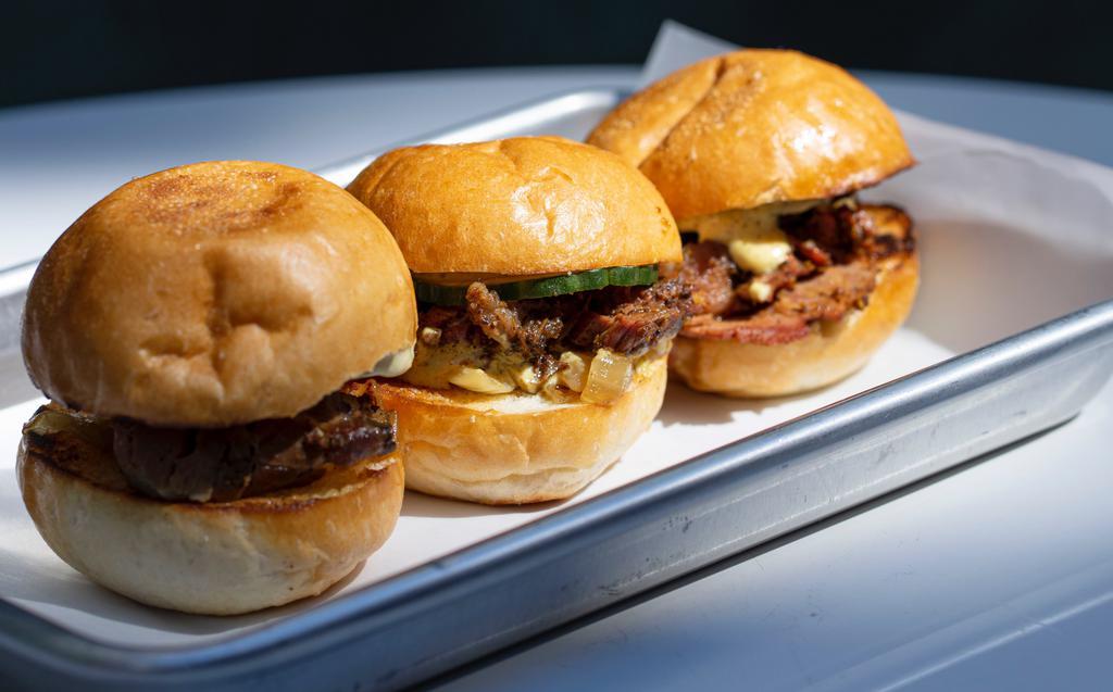 Pastrami Sliders · hot pastrami, caramelized onion, quick pickle, house aioli, three acme baby, pain de mie rolls