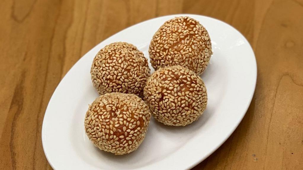 Sesame Ball (4 Pc) · Light sticky rice-flour balls stuffed with sweet lotus seed puree, rolled in sesame seeds deep-fried until golden brown and crusty.
