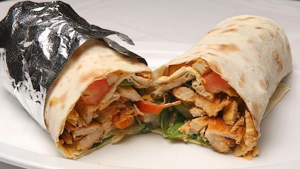 Chicken Shawarma Wrap · The chicken shawarma wrap includes chicken shawarma with tomato, cucumber, hummus, tahini, and cucumber pickles all wrapped in lavash bread