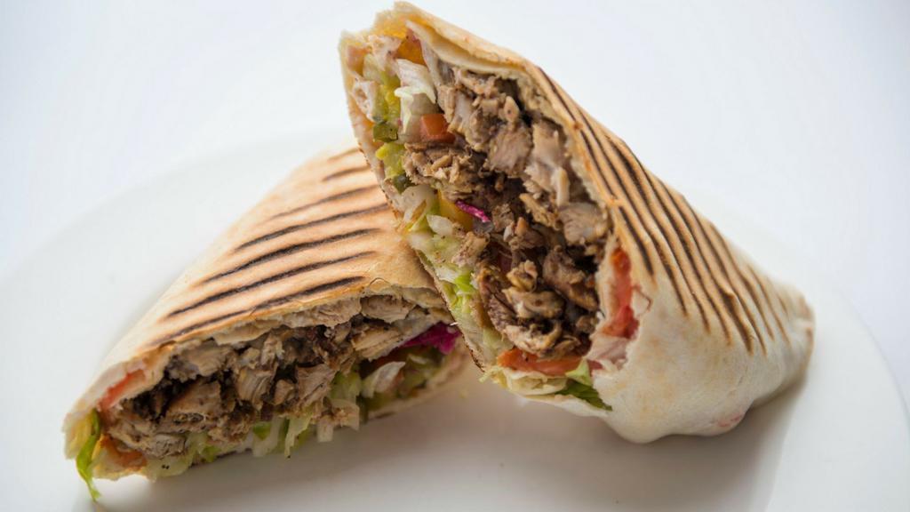 Beef Shawarma Wrap · The beef shawarma wrap includes beef shawarma with grilled onions, tomato, cucumber, hummus, tahini, and cucumber pickles all wrapped in lavash bread