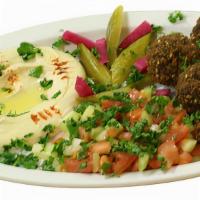 Falafel Plate · The Falafel plate includes falafel with a side of salad, hummus, bread, turnip pickles and c...