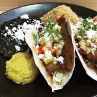 Baja Fish Tacos · Two beer-battered fish tacos with chipotle aioli and topped with roasted pineapple sauce. in...