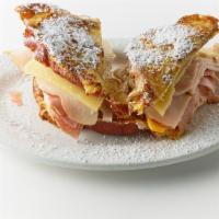 Monte Cristo · Grilled ham, turkey, Swiss, cheddar, and an egg on buttered sourdough or cinnamon swirl brea...