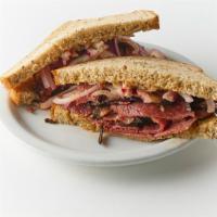Hot Corned Beef · 6oz. Homemade sliced hot corned beef on rye with grilled red onions and deli mustard.
