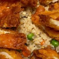 38. Fried Chicken Over Fried Rice · Deep fried-battered chicken breast over egg-fried rice, peas and carrots serve with sweet an...