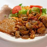 16. New Eritrea Special · Tenderized boneless chicken mixed with mushrooms sautéed with onions tomatoes, garlic and au...
