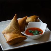 Samosas · Hand-made wheat-flour wraps fried and filled with potatoes, onions, and secret spices. Serve...