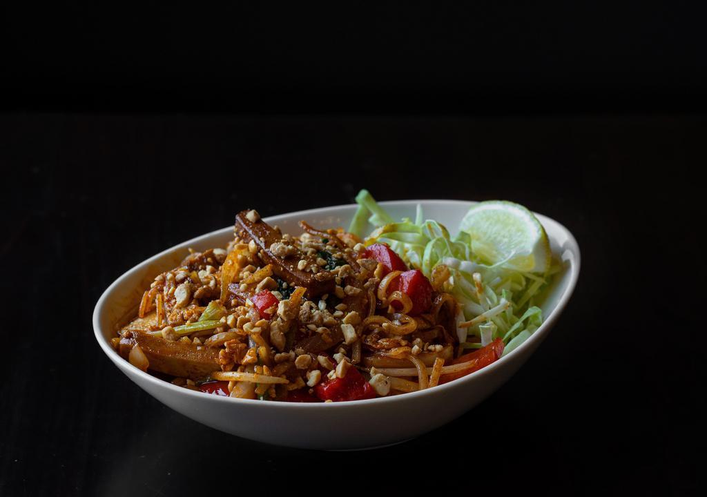 Burmese Style Pad Thai With Tofu · Rice noodles mixed with tofu, red bell peppers, onions, scallions, bean sprouts, egg, tamarind, paprika. Garnished with shredded cabbage, peanuts, and lemon.