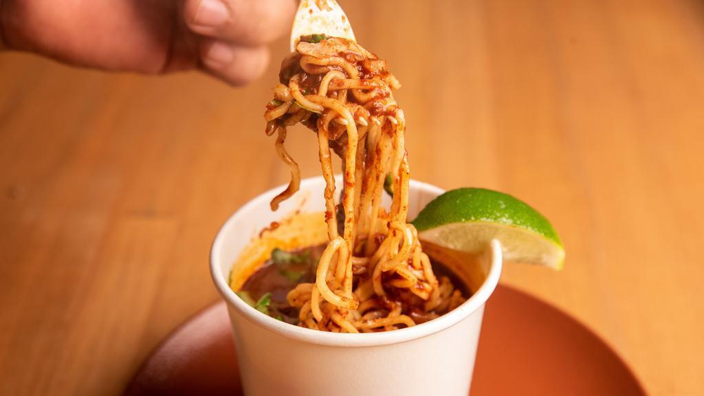 Ramen · 16 oz cup of Halal Beef Birria and ramen noodles in a savory broth with onions, cilantro salsa on the side.
