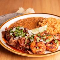 Surf and Turf · Birria, grilled shrimp, onions, cilantro, lime, rice, beans and fresh heirloom blue corn tor...