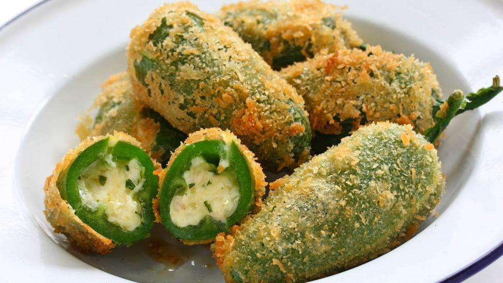 Jalapeño Poppers · Spicy jalapeños, stuffed with cheese and deep fried to a golden brown.