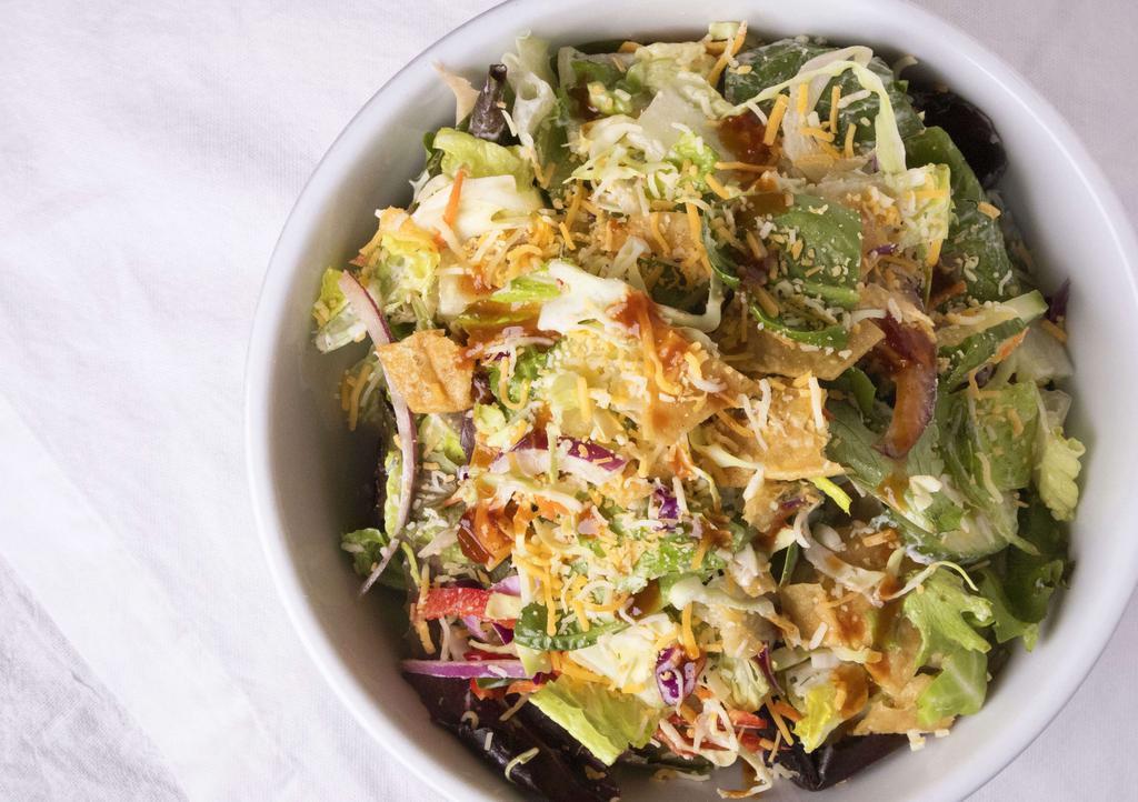 Backyard Salad · English cucumber, shredded cabbage, carrots, mixed greens,  crispy tortilla chips, cilantro, cheddar cheese, house-made ranch dressing, drizzle of BBQ sauce.

don't forget to add protein!
