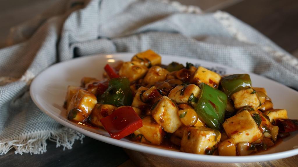 Kung Pao Paneer · Gluten free. Spicy.  Cubed paneer, bell pepper, water chestnut, peanuts, dry red chili. Dry for $1 extra.