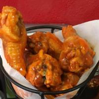 Buffalo Wings · One dozen of our signature wings. Available in spicy and BBQ. Served with ranch or blue chee...