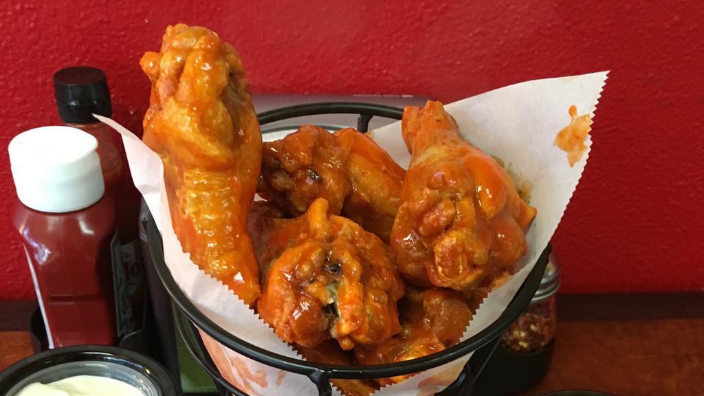 Buffalo Wings · One dozen of our signature wings. Available in spicy and BBQ. Served with ranch or blue cheese dip.