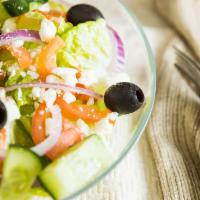 Greek Salad · Crisp romaine lettuce, red onion, roma tomatoes, cucumber, black olive & feta cheese.