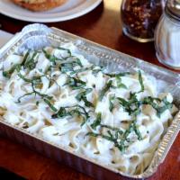 Fettuccine Alfredo  · Fettuccine baked with Alfredo Sauce topped with fresh basil.