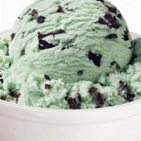 Minted Ice Cream · A large scoop of mint ice cream, sandwiched between two old-fashioned oatmeal cookies, and d...