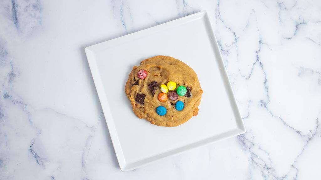 M&M OG Cookies · Made from chocolate chunk cookie dough topped with Hershey's Kisses, semi sweet chunks and Milk chocolate chunks. Oversized Cookie.