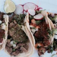 35. Tacos · Small corn tortilla, meat, cilantro, onions, and red salsa.