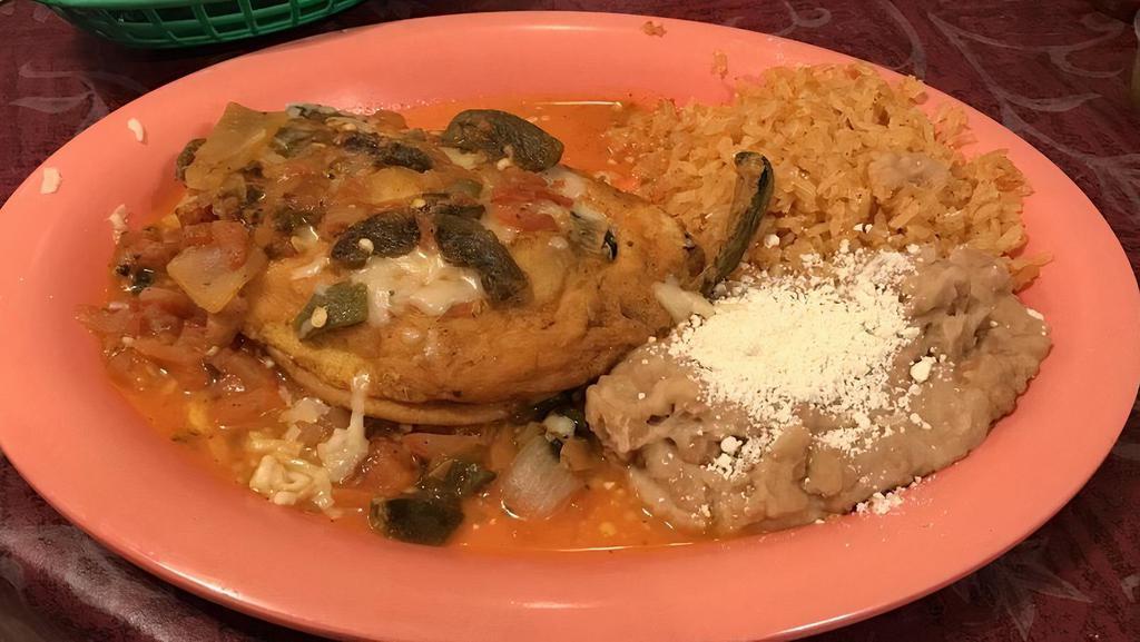 15. Chile Relleno · Mild poblano chili stuffed with Mexican cheese, covered with scrambled egg, and ranchero sauce.