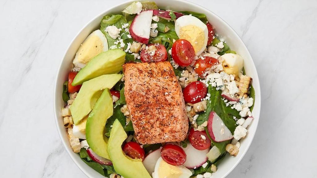 Blackened Salmon Cobb · Blackened Salmon, fresh avocado, blue cheese crumbles, tomato, egg, grilled corn, pickled radish. green onion and romaine and spinach with lemon vinaigrette