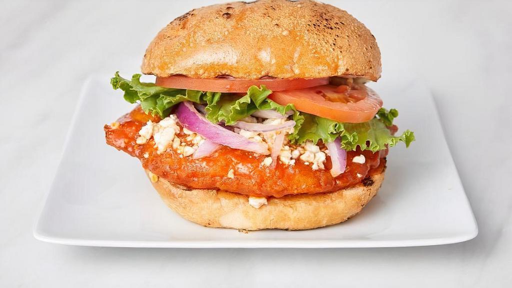 Spicy Buffalo Sandwich · Crisp-fried chicken breast, dipped in house-made buffalo sauce with crumbled blue cheese, red onion, lettuce, tomato, and mayo on a sourdough roll.