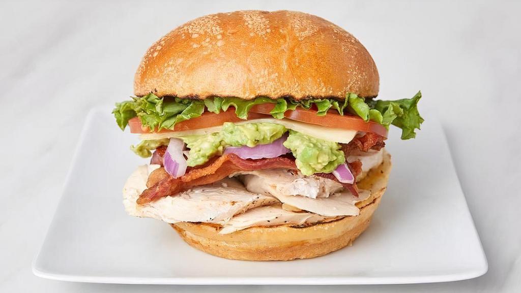 Chicken Club · Jack's Chicken Club includes swiss cheese, crisp bacon, avocado, leaf lettuce, red onion, tomato, mayo, and honey mustard on a sourdough roll.