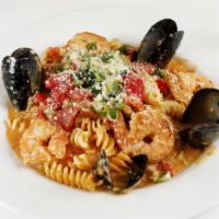 Pasta Orleans · Sautéed shrimp, crawfish, mussels, and andouille sausage with fusilli pasta in a spicy red p...