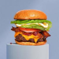 Wake & Bacon Burger · American beef patty topped with bacon, fried egg, avocado, melted cheese, lettuce, tomato, o...