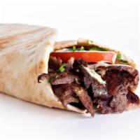 Spicy Beef Shawarma Wrap · Spicy beef shawarma sliced with hummus, lettuce, tomatoes, onions, pickles topped with chef'...