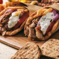 Combo Gyro Wrap · Thinly sliced beef & chicken gyro with lettuce, tomatoes, onions, tzatziki sauce on warm pit...