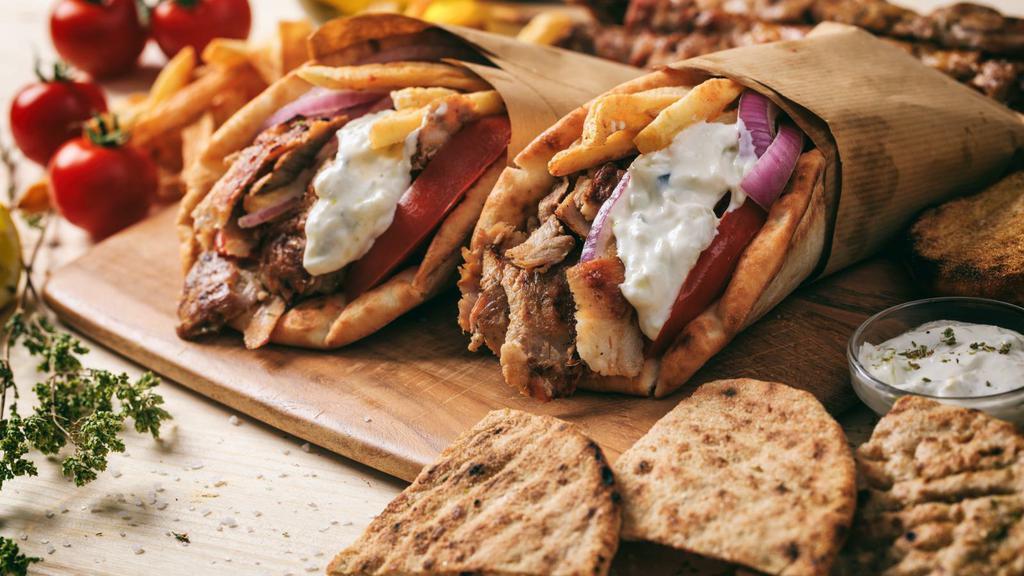 Combo Gyro Wrap · Thinly sliced beef & chicken gyro with lettuce, tomatoes, onions, tzatziki sauce on warm pita bread.