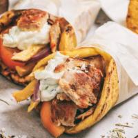 Chicken Gyro Wrap · Fresh thin sliced chicken gyro with lettuce, tomatoes, onions, tzatziki sauce on pita bread.