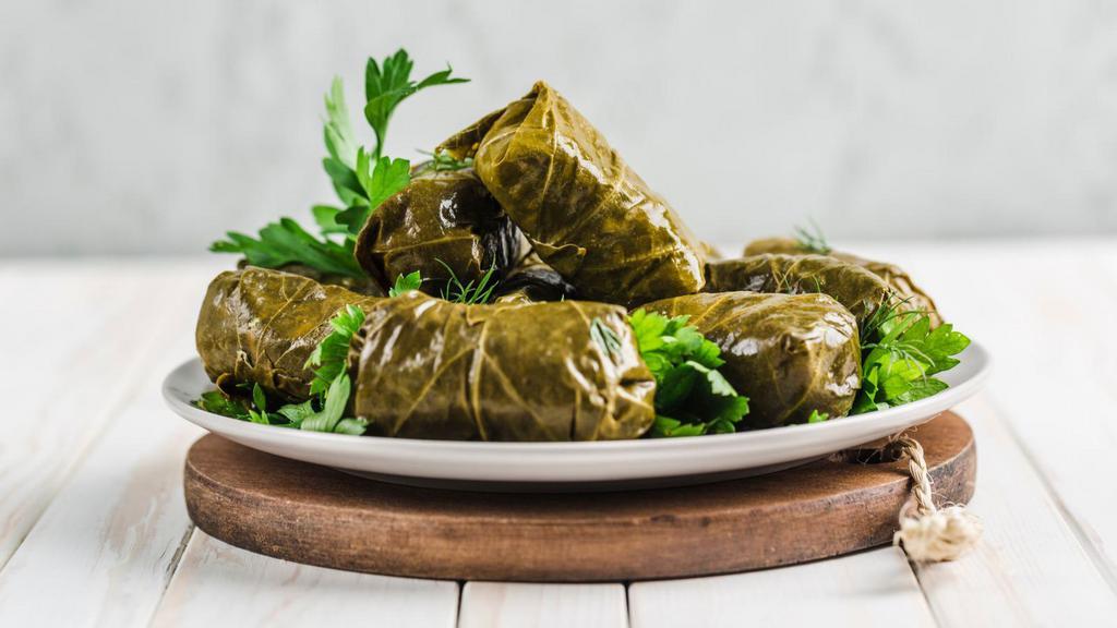 Dolma · Mediterranean flavored grape leaf appetizers filled with herbs and rice.