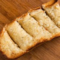 Garlic Bread · A delightful blend of butter, Parmesan cheese, fresh garlic, basil & oregano on a 1/4 loaf o...