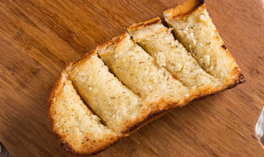Garlic Bread · A delightful blend of butter, Parmesan cheese, fresh garlic, basil & oregano on a 1/4 loaf of French bread.