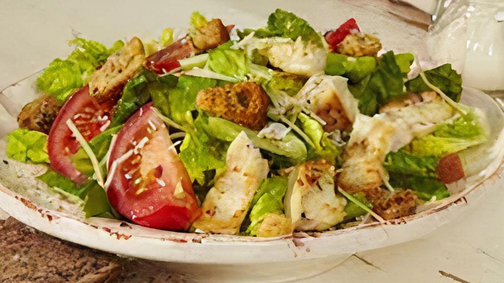 Caesar Salad · Crisp lettuce, tomatoes, red onions, red cabbage, pepperoncini, black olives, Parmesan cheese & croutons.