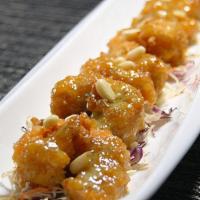 Crispy Honey Prawns · Six tiger shrimp deep fried in honey wasabi sauce with pine nuts on top