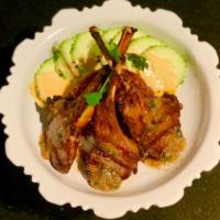 Garlic Lamb Chops · Australian lamb chops grilled to perfection topped with garlic sauce served  with fresh cucu...
