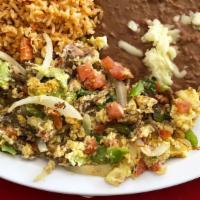 Huevos Con Machaca · Shredded beef scramble. Served with rice and beans.
