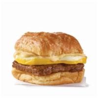 Sausage, Egg & Swiss Croissant  · A fresh-cracked grade A egg and grilled sausage covered in creamy swiss cheese sauce on a fl...