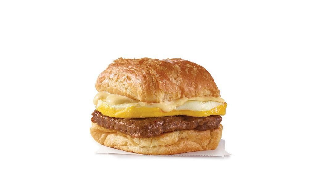Sausage, Egg & Swiss Croissant  · A fresh-cracked grade A egg and grilled sausage covered in creamy swiss cheese sauce on a flaky croissant bun. There’s a lot going on in this simple sandwich and it’s all delicious.