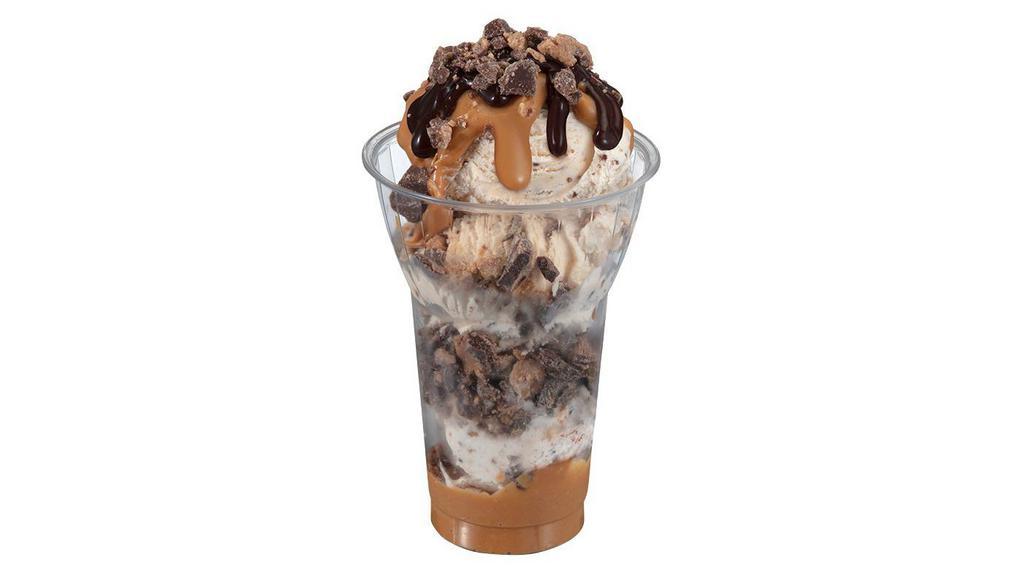 Reese'S® Peanut Butter Cup Layered Sundae · Three scoops of Reese’s Peanut Butter Cup ice cream topped with layers of Reese's Peanut Butter Sauce, chopped Reese's Peanut Butter Cups, and hot fudge!
