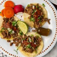 Taco Regular · meat choice, cilantro, cebolla, y salsa.