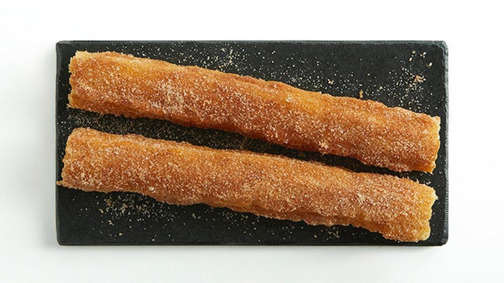 Two Churros · Dusted in cinnamon sugar and served warm.