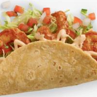 Baja Shrimp Taco · Cooked to perfection in a chipotle and garlic marinade. The Baja Shrimp Taco is topped with ...