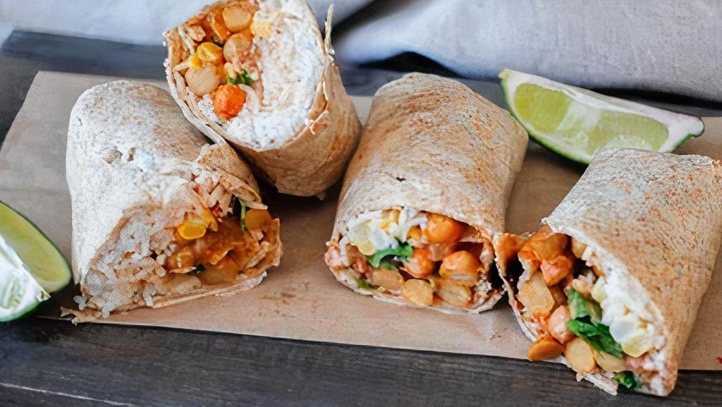 Chickpea Wrap · Vegan. Tortilla wrap filled with home made spicy chickpea, greens, cucumber, and black olives.