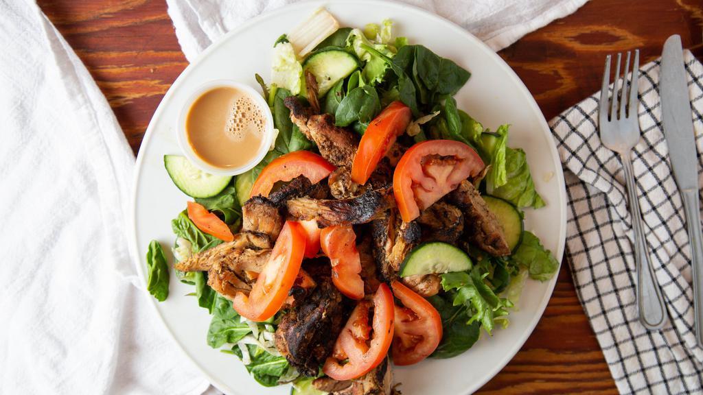 Jerk Chicken Salad · Marinated and grilled chicken, served in house made jerk sauce. With a large bed of mixed greens topped with cucumbers, tomatoes, black olives, and choice of dressing.