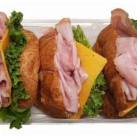 Ham Croissant Sandwiches, 3 Ct · Kretschmar ham off the bone, sliced Cheddar cheese, green leaf lettuce on a mini croissant.